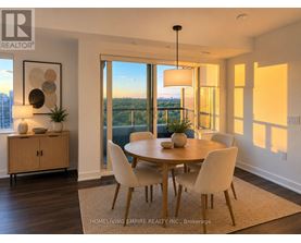 A dining room with a table set for four and a view of the city.