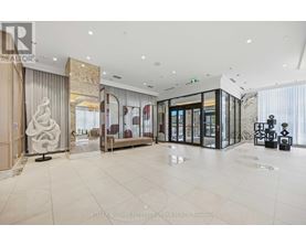 A spacious, well-lit lobby with a marble floor and modern furnishings.