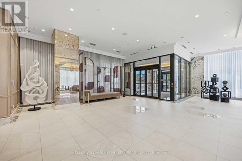 A spacious, well-lit lobby with a marble floor and modern furnishings.