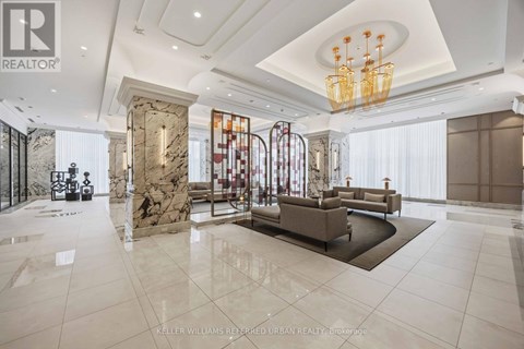 A spacious living room with a marble floor and a chandelier.
