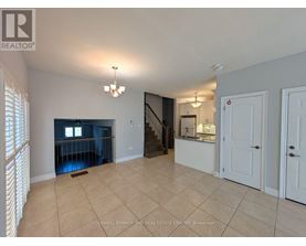 A spacious room with a staircase leading to the upper floor.