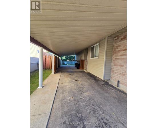 A long covered walkway between two houses.