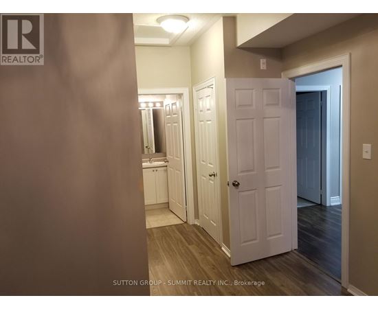 A hallway with a white door and a white cabinet.