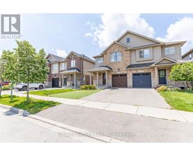 A row of houses with a realtor logo in the corner.