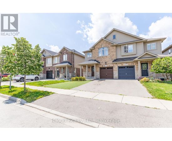 A row of houses with a realtor logo in the corner.