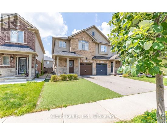 A real estate brokerage photo of a house with a front yard and a driveway.