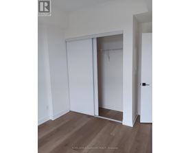 A room with a white door and a white wardrobe.