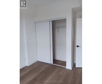 A room with a white door and a white wardrobe.