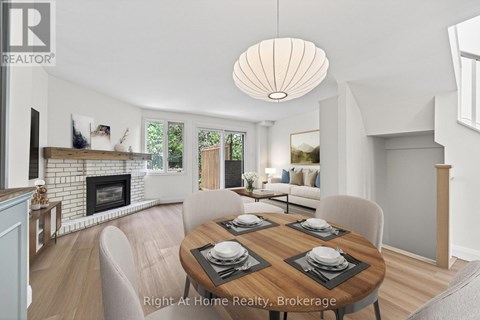 A dining room with a wooden table set for four.