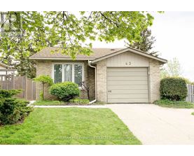 A house with a garage door numbered 43 is for sale.