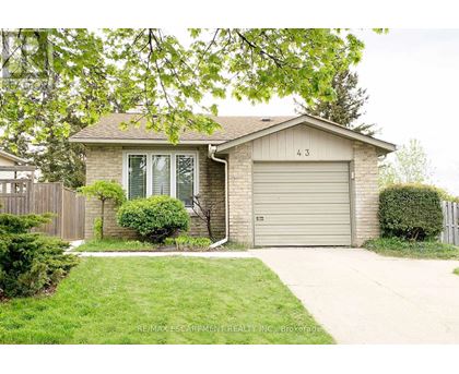 A house with a garage door numbered 43 is for sale.
