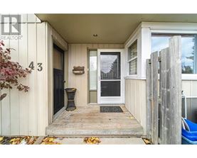The image shows the front porch of a house with the number 43 on the wall.
