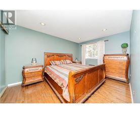 A bedroom with a large bed and wooden furniture.