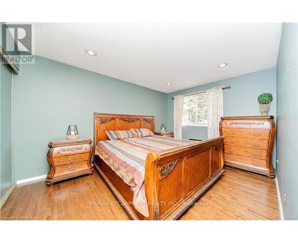 A bedroom with a large bed and wooden furniture.