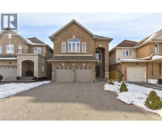 A large house with a driveway in front of it.