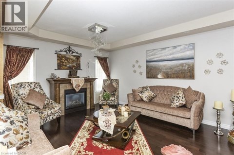 A living room with a fireplace and a painting on the wall.