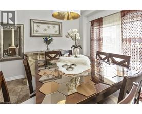 A dining room with a table set for a meal.