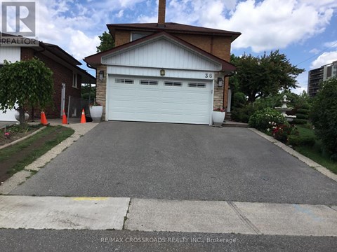 A garage with a white door is in front of a house.
