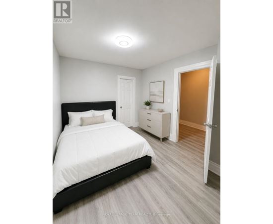A bedroom with a large bed and a dresser.