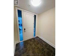 A room with a white door and a tiled floor.