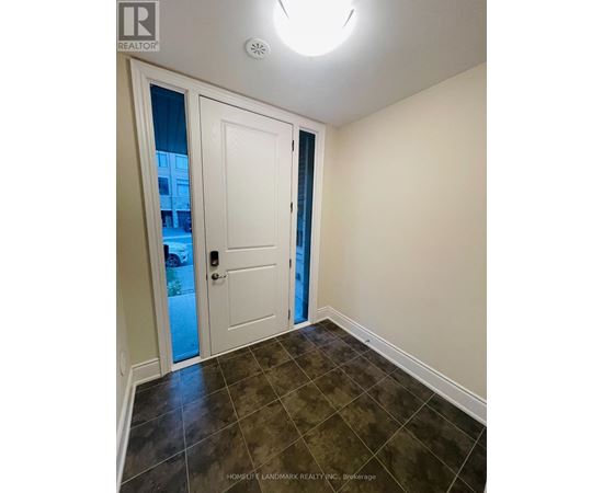 A room with a white door and a tiled floor.