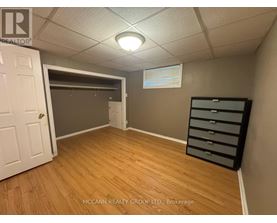 A brokerage office with a white door and a wooden floor.