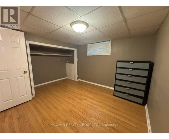 A brokerage office with a white door and a wooden floor.