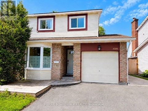 A two-story house with a garage is for sale.
