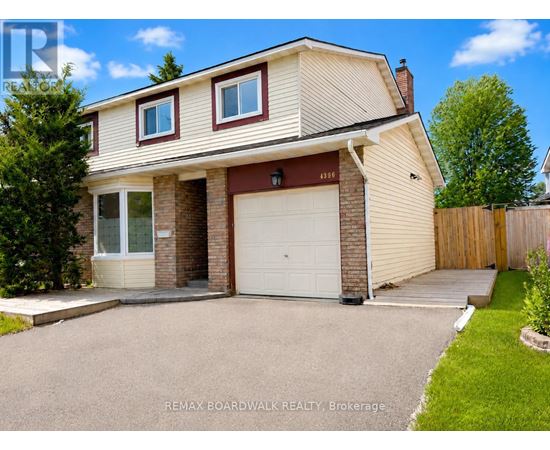 A two-story house with a garage is for sale.