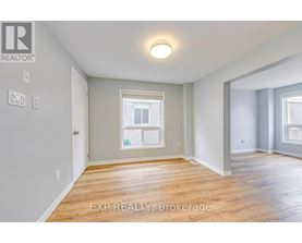 A room with a window and wooden flooring.