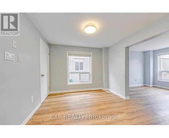 A room with a window and wooden flooring.