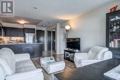 A living room with a white couch and a television.