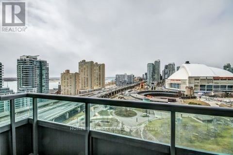 A cityscape viewed from a high-rise building with a realtor logo in the corner.
