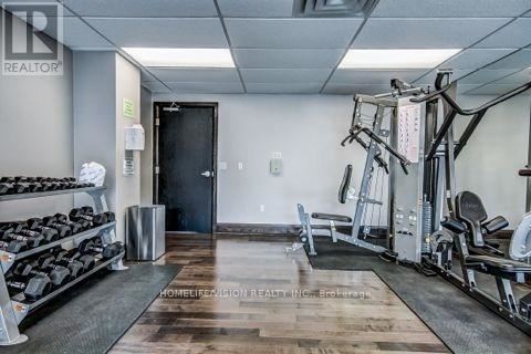 A gym with a variety of equipment including weights and cardio machines.