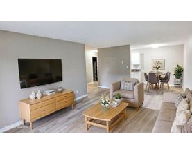A living room with a wooden dresser and a coffee table.