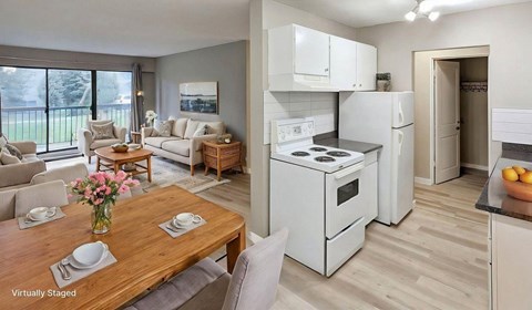 A modern kitchen with a wooden table and chairs in the foreground.