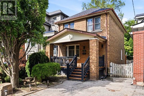 A house with a brick facade and a black metal staircase.