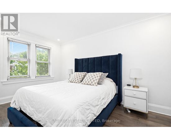A bedroom with a white bed and a blue headboard.
