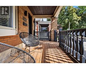 A balcony with a chair and a railing.