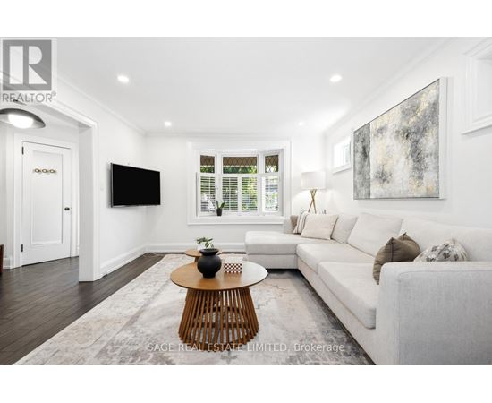 A modern living room with a white couch and a wooden coffee table.