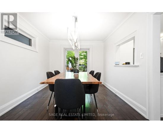 A dining room with a long table and chairs.