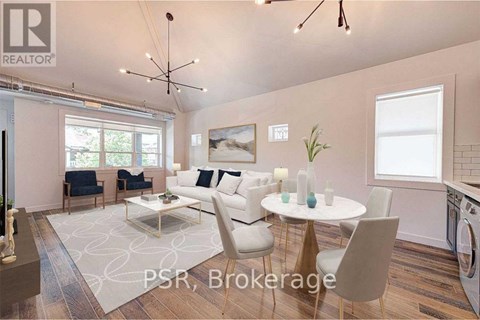 A modern living room with a dining table set up with white chairs.