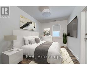 A bedroom with a bed, nightstand, lamp, and a painting on the wall.