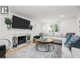 A living room with a fireplace, a television, a couch, and a coffee table.