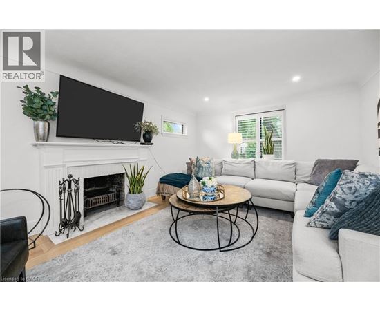 A living room with a fireplace, a television, a couch, and a coffee table.
