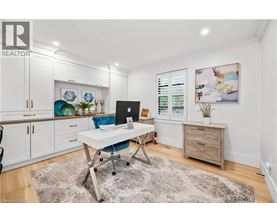 A room with a desk and a chair in it.