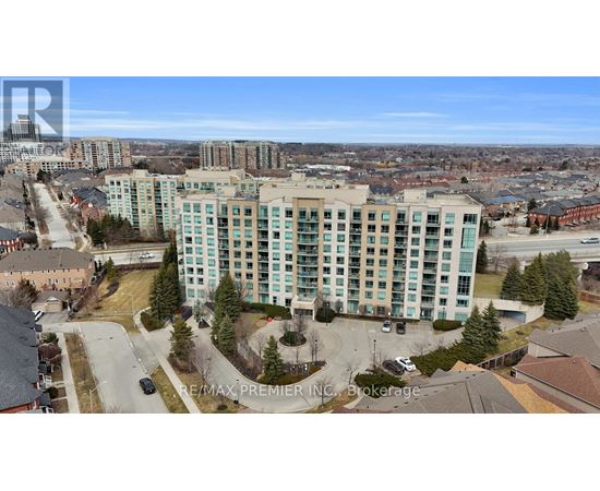 A large multi-story building with a parking lot in front.