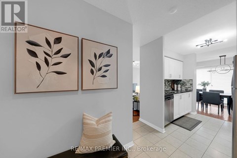 A living room with two leaf paintings on the wall.