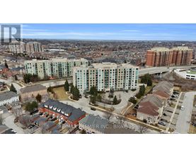 A bird's eye view of a city with apartment buildings and a highway.