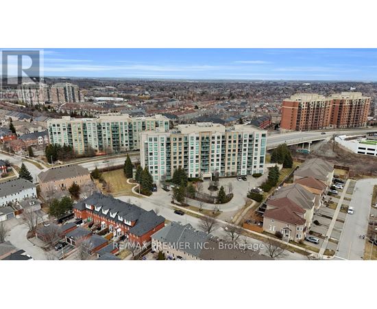 A bird's eye view of a city with apartment buildings and a highway.